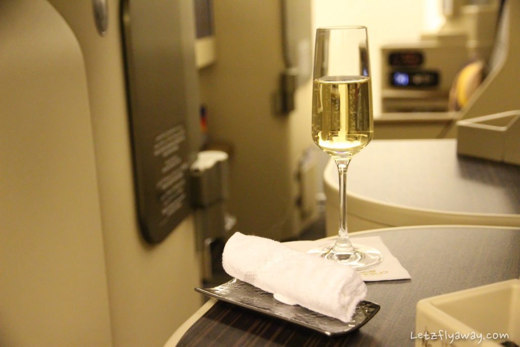 Etihad Business Class Boeing 777 champagne and cold towel
