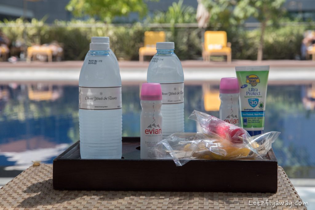 The Oberoi Dubai pool amenities with sunscreen, water, Evian facial spray and icy fruit bars