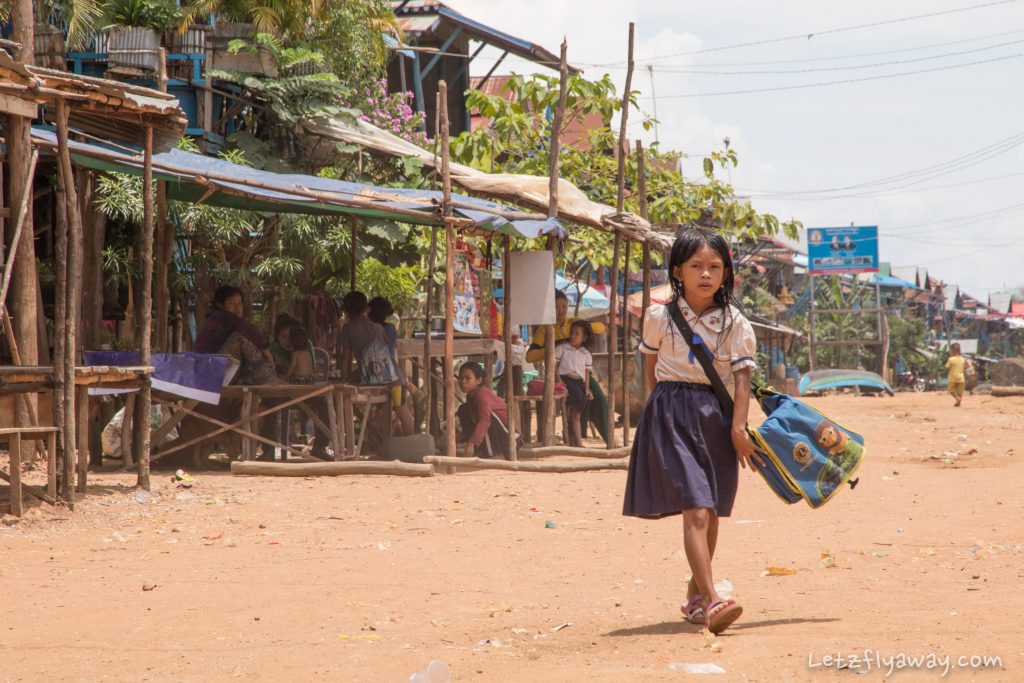 Cambodian girl going to school in the floating village