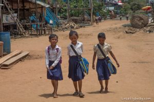 Cambodian kids going to school in the floating village